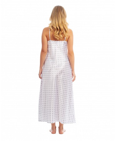 Woman wears elegant long white satin nightgown with polka dot pattern