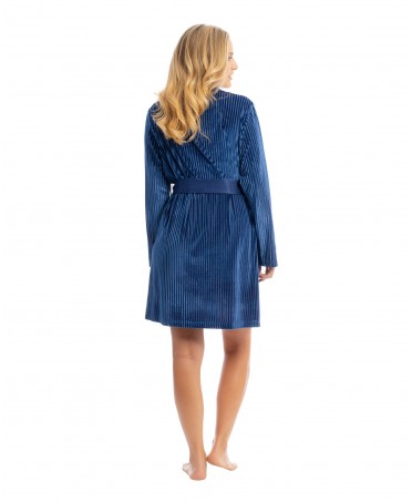 Woman in blue velvet Christmas short dressing gown with belt