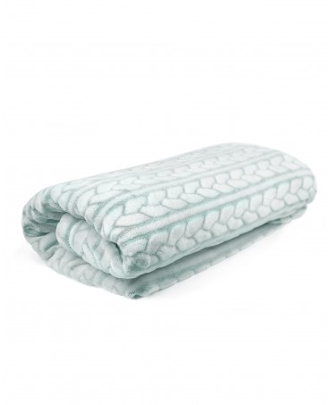 A woven flannel blanket with green and white braid folded on itself