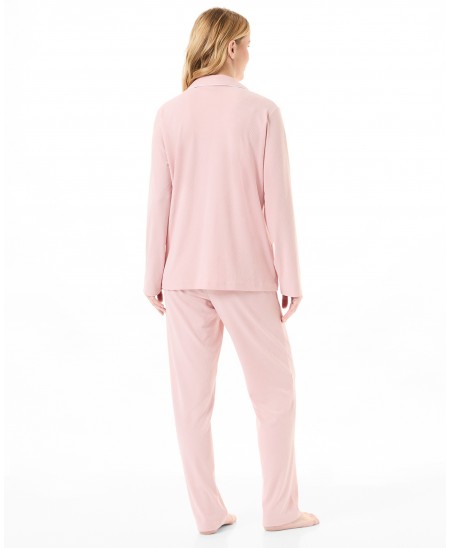 Rear view of woman in long-sleeved pink ribbed winter pyjamas with long sleeves