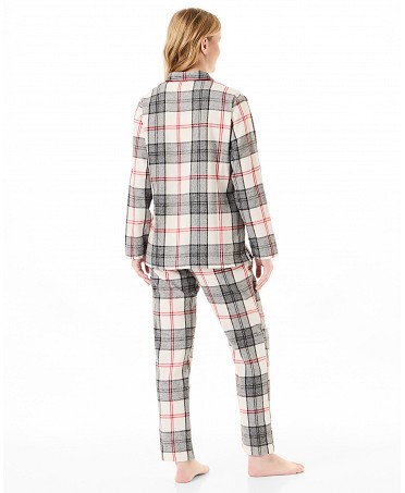 Rear view of a woman wearing plaid pyjamas for winter.