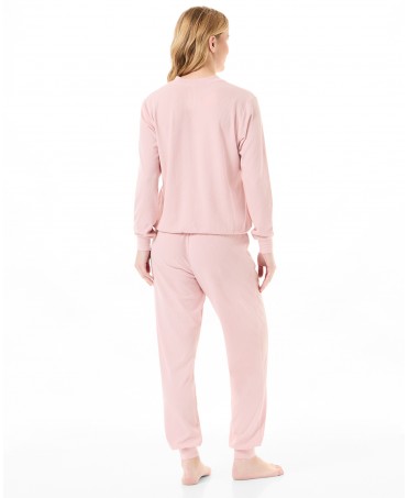 Rear view of woman in pink long ribbed pyjamas for winter