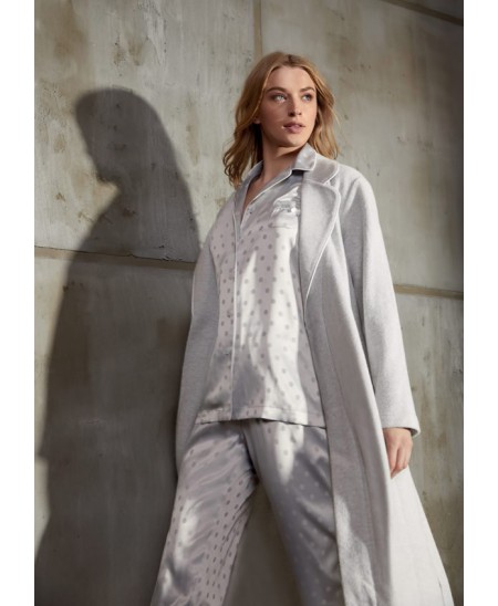 Woman wears grey fleecy long dressing gown with matching pyjamas