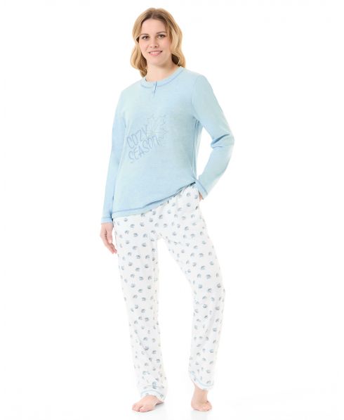 Woman in light blue winter pyjama jacket with embroidery and plain trousers with leaf print
