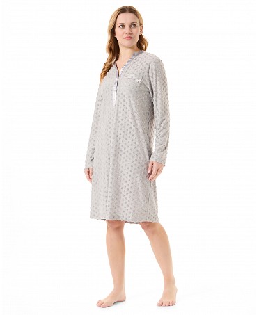 Woman in long grey knitted nightdress with polka dot pattern