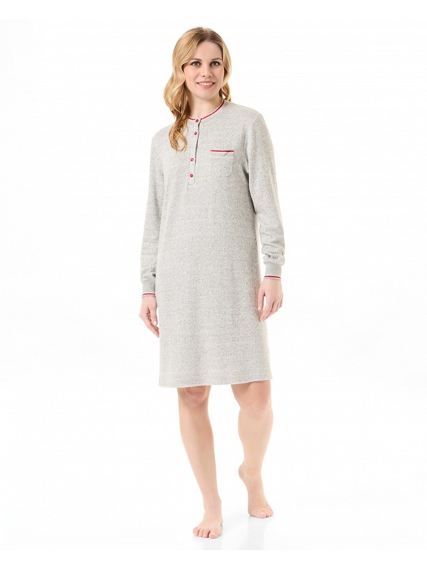 Woman in plain nightdress, round neck with buttons, long sleeves with cuffs.