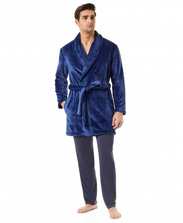 A man dressed in a short blue knotted dressing gown and trousers