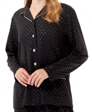 Detail view of black pyjama jacket with pockets and silver dotted pattern and piping