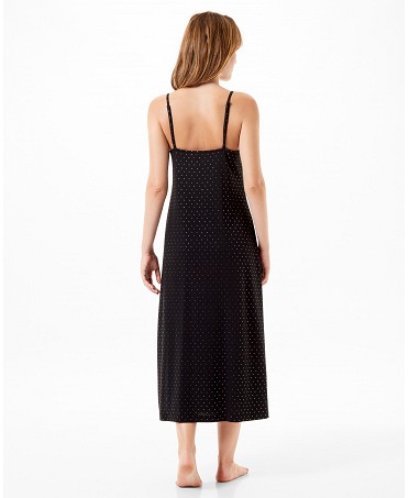 Rear view of woman in elegant long black nightdress with straps and silver polka dots