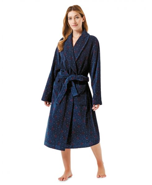 Woman in long terry towelling bathrobe with pockets and christmas motifs