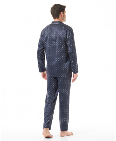 Back view of man in blue satin Christmas pyjamas with polka dots