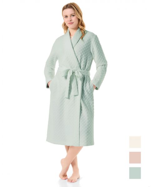 Woman in a long green circular knitted tuxedo-style dressing gown