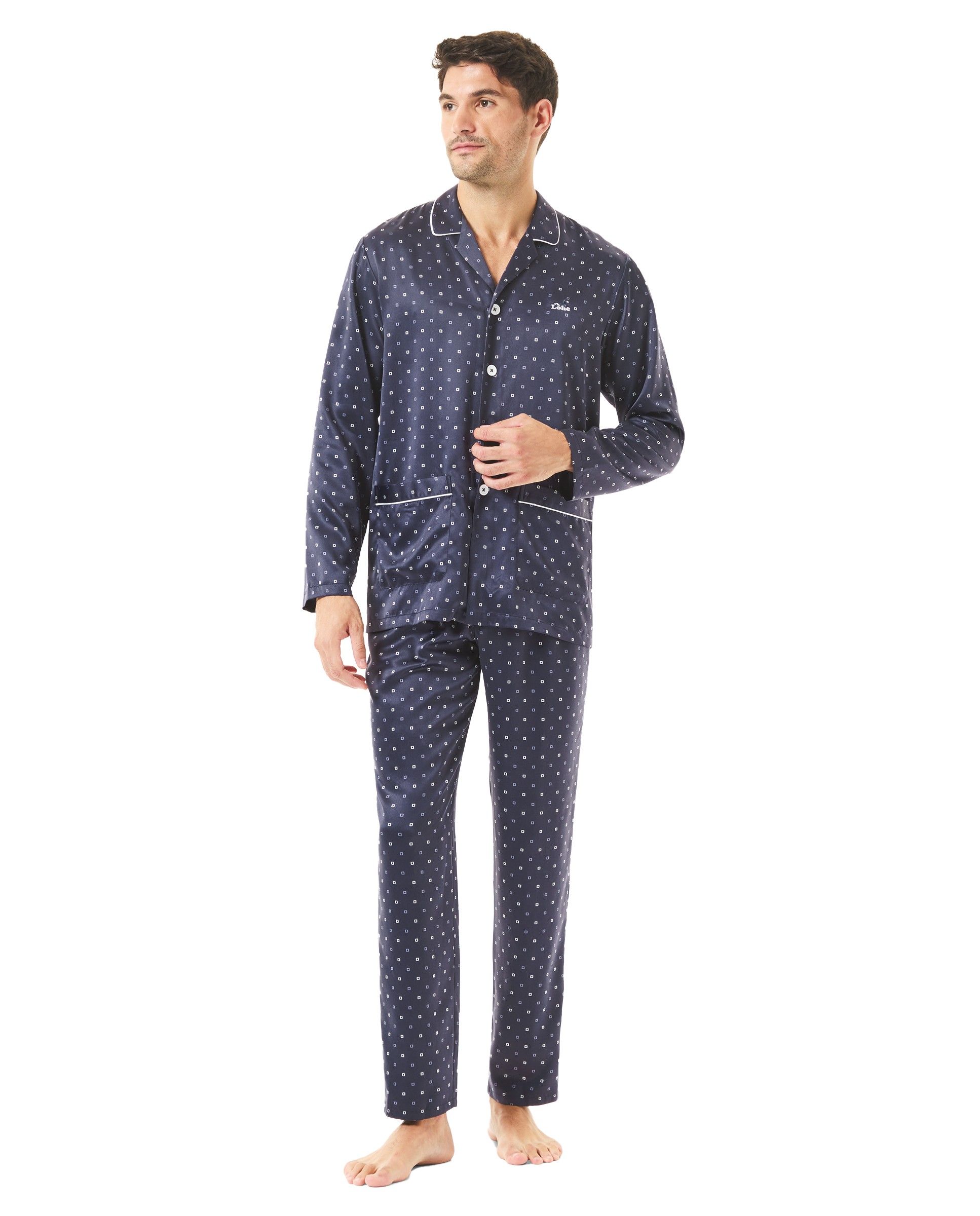 Man in blue satin Christmas pyjamas with open pockets and polka dot print