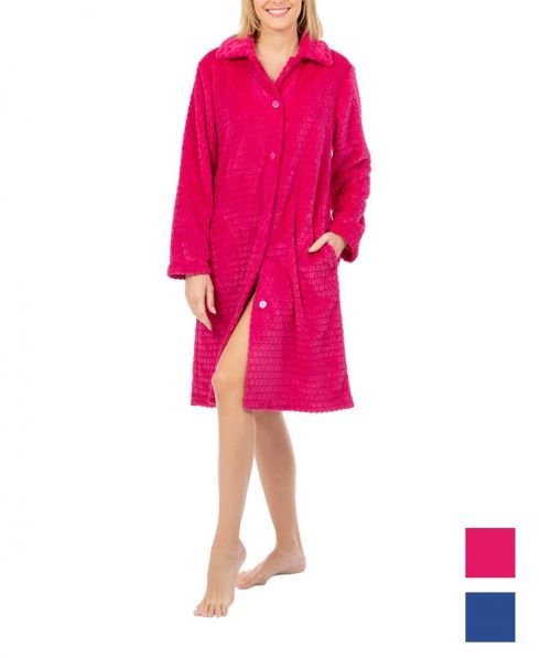 A woman in a long, comfortable winter dressing gown, fuchsia-coloured with buttons on a white background.