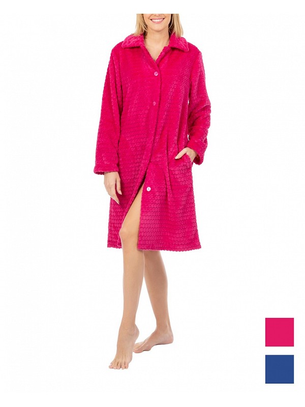 A woman in a long, comfortable winter dressing gown, fuchsia-coloured with buttons on a white background.