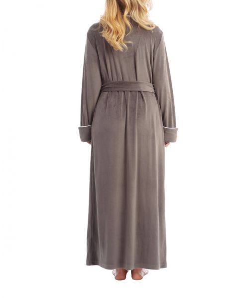 Woman wears warm velvet long knotted velvet robe with pockets for winter