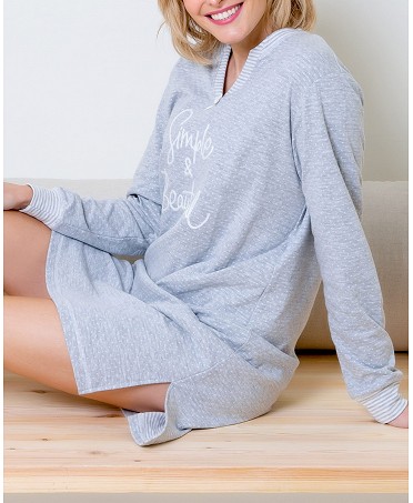 Woman in comfortable grey short nightgown with embroidery on chest and elbow patches