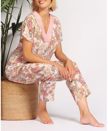 Woman in long summer pyjamas with paisley print and V-neckline