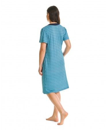 Woman in a short, short-sleeved beach dress in shades of green with an oval print.