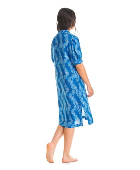 Woman in blue leaf print summer dress