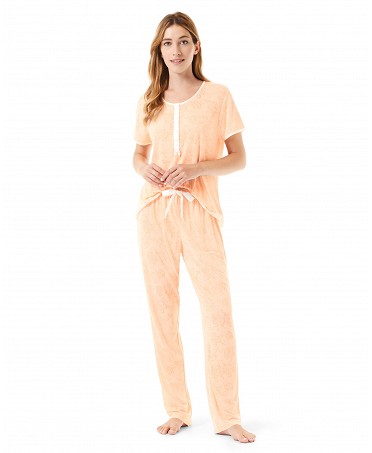 A woman wearing an orange summer pyjama set.