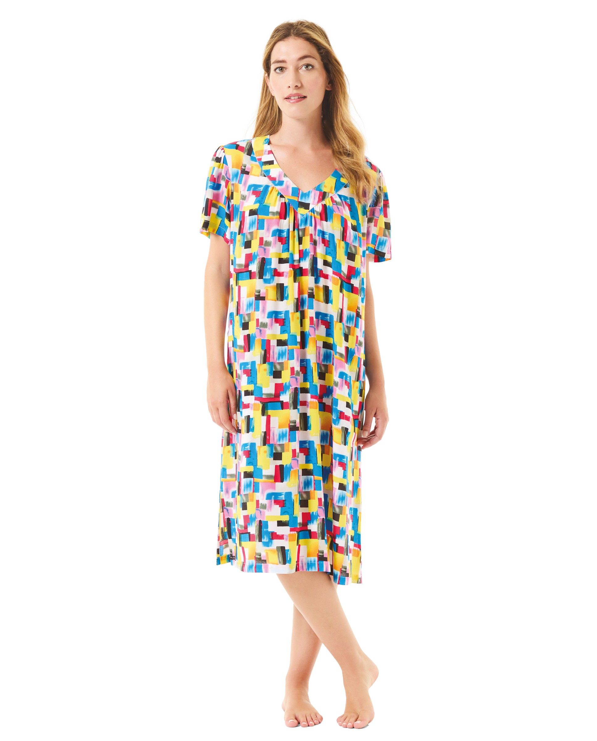 Woman wears short-sleeved summer dress with colourful geometric print