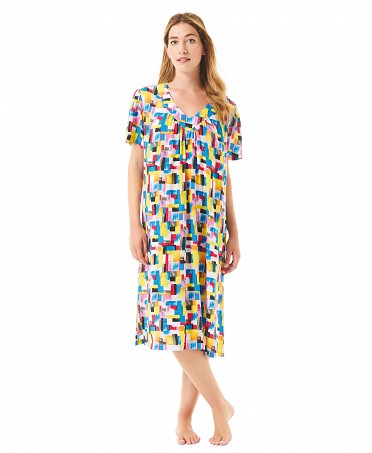 Woman wears short-sleeved summer dress with colourful geometric print