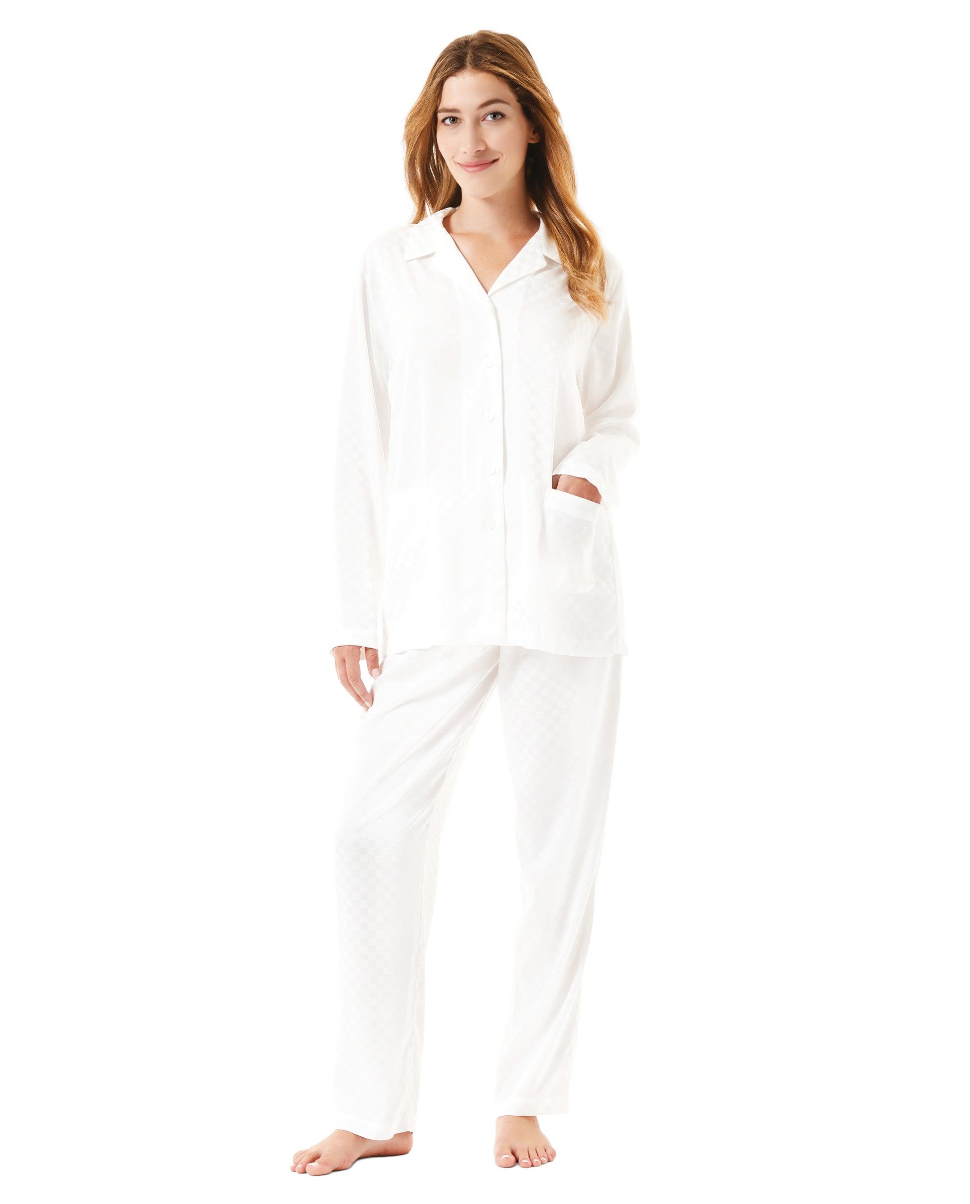A woman wears an ivory jacquard printed long pyjama set open with buttons.