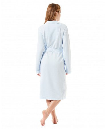 Rear view of a woman wearing a light blue knitted housecoat.