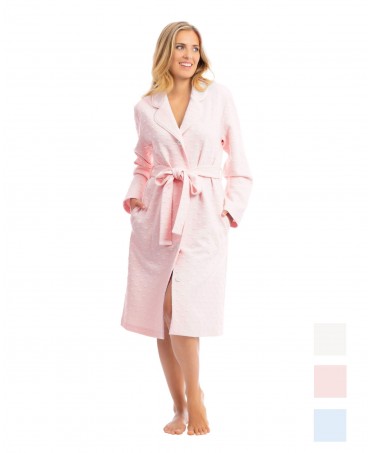 Woman in pink long buttoned dressing gown with embossed heart design