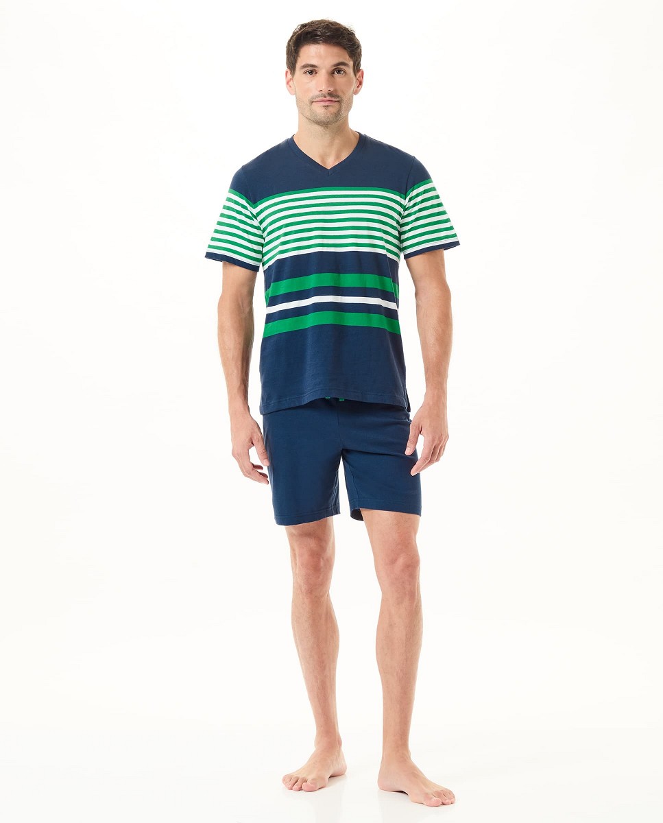 A man wearing summer pyjamas with a navy striped T-shirt and shorts.