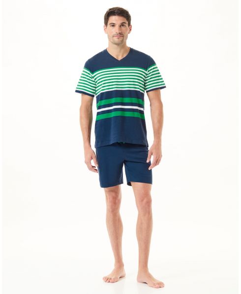 A man wearing summer pyjamas with a navy striped T-shirt and shorts.