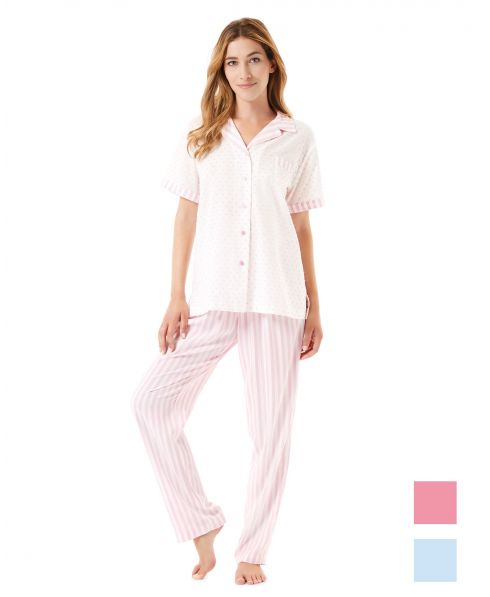 Una mujer viste un conjunto de pijama de verano abierto en plumeti a rayas rosa y blanco.