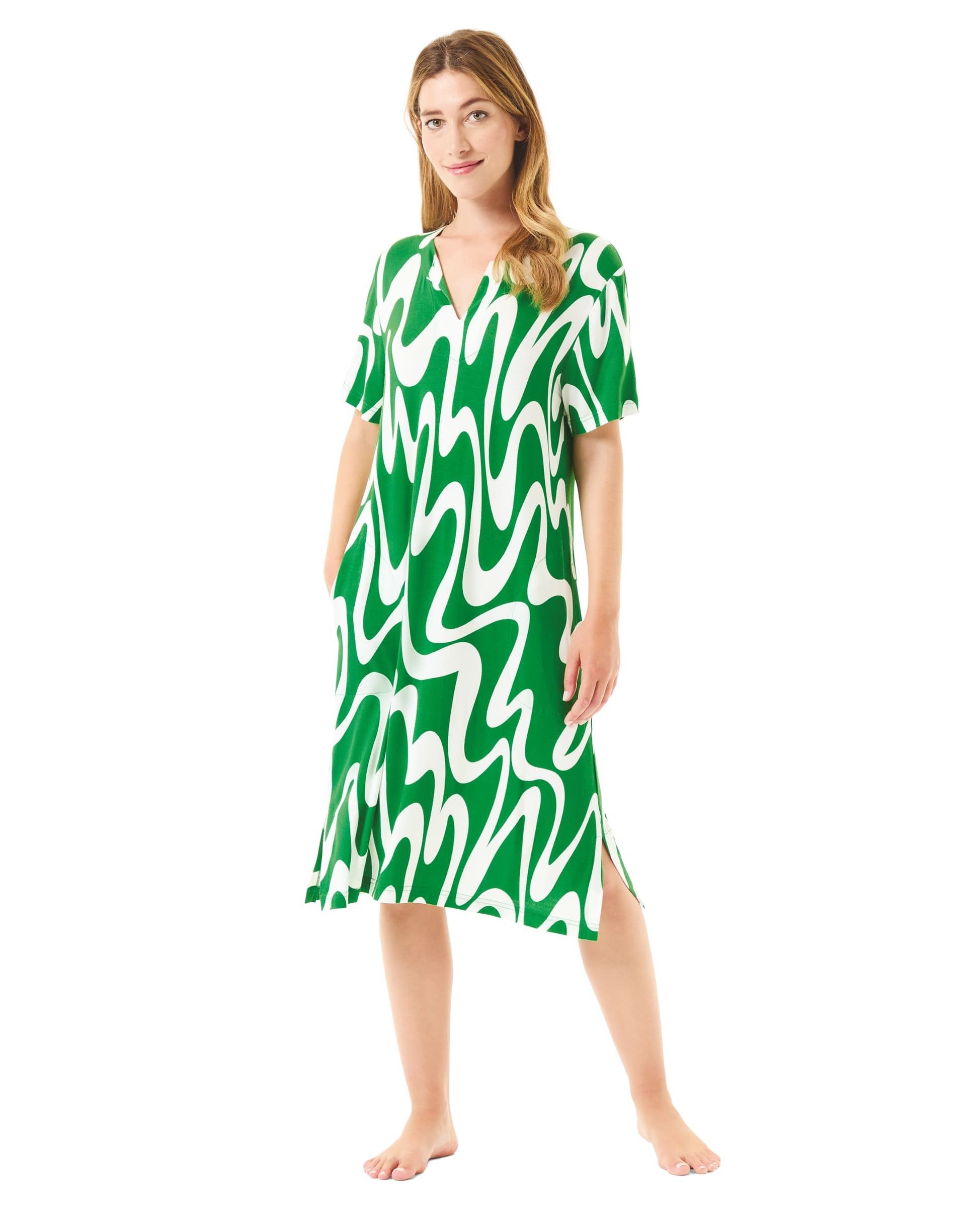 Woman wearing summer swim dress with green wave print and short sleeves