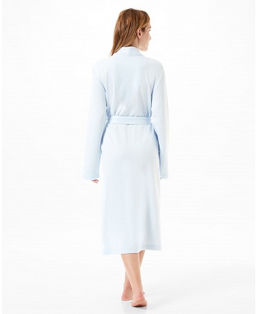 Rear view of a woman wearing a light blue knitted housecoat.