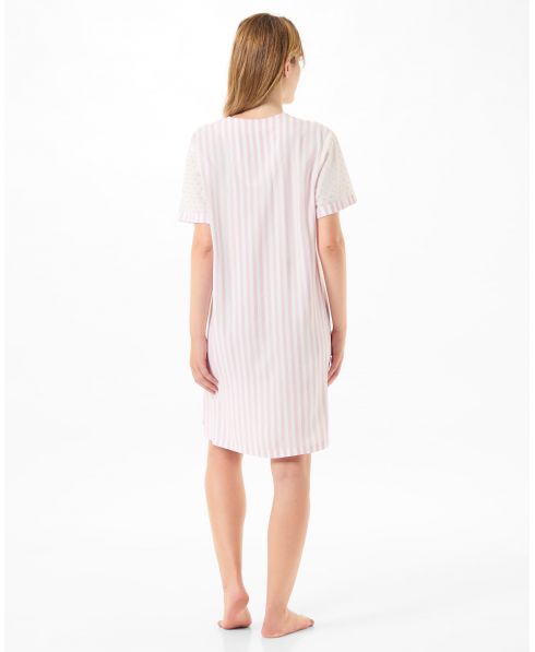 Woman with her back turned in a short pink plumeti nightdress