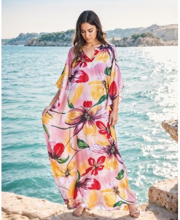 Woman with natural silk kaftan with flowers in pink tones