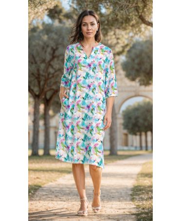 Woman in a Short beach dress with short sleeves. V-neck and colourful floral print.