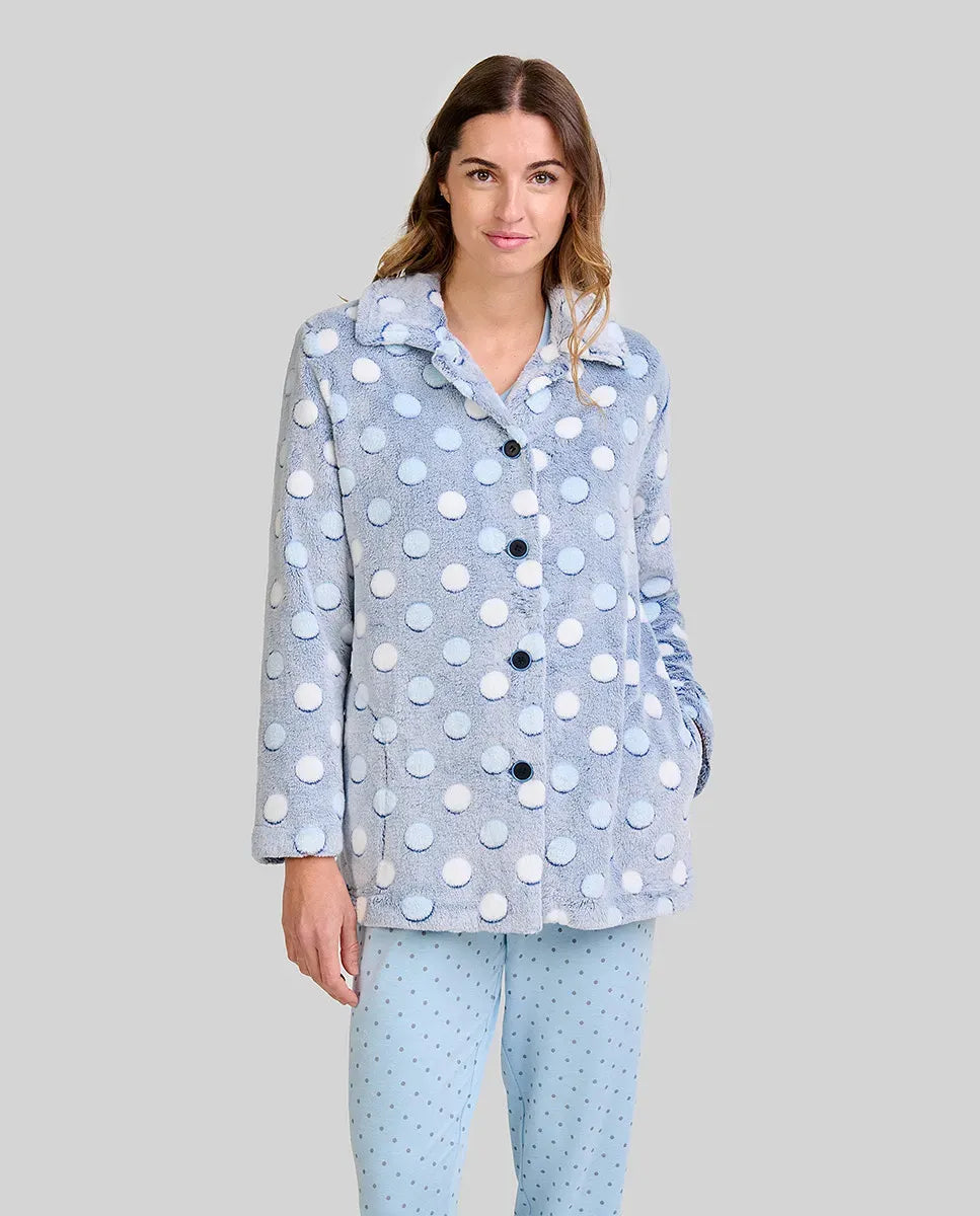 Mujer luce cómoda bata corta azul celeste con lunares y abertura de botones para invierno