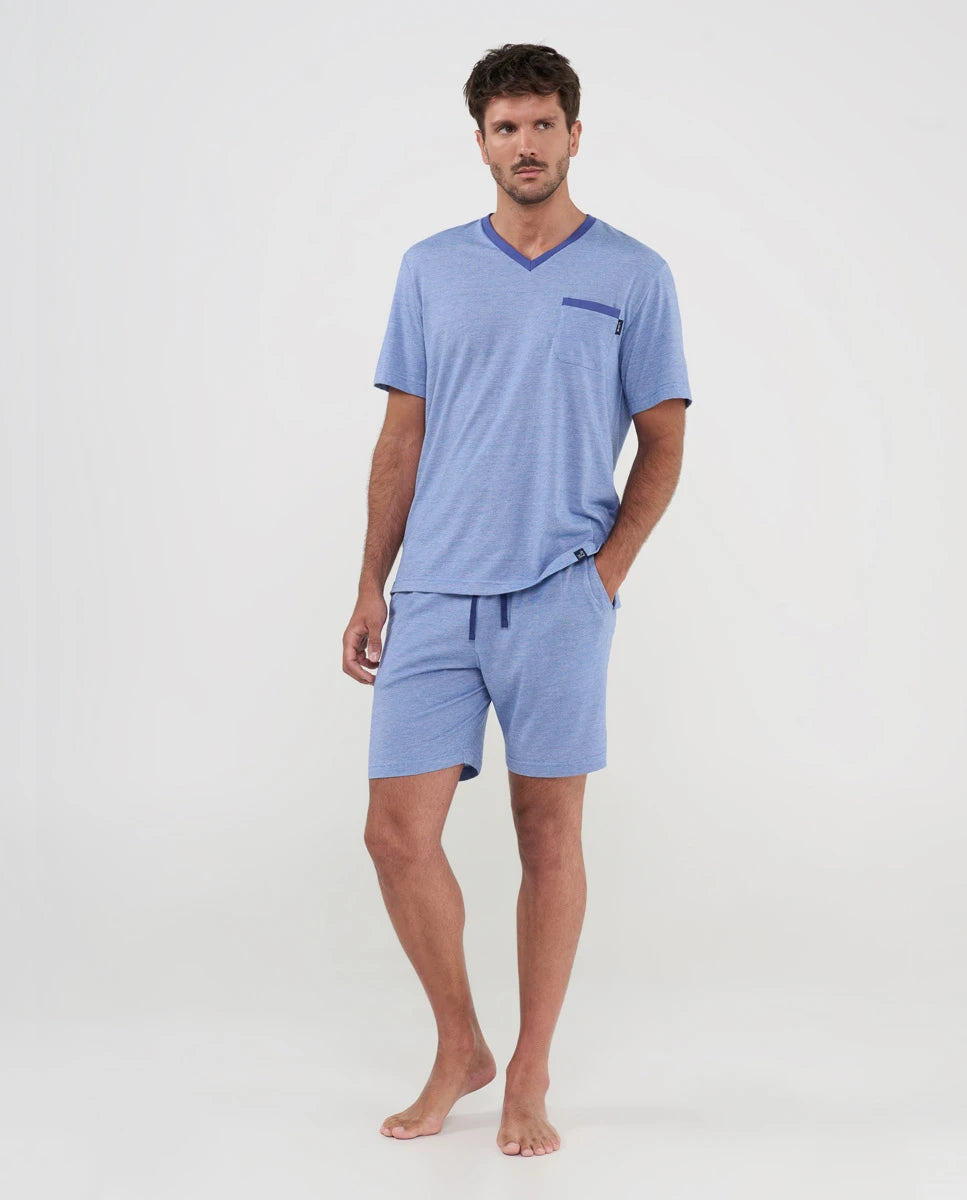 Hombre luce pijama fresco de verano de punto azul con cuello pico y bolsillo en contraste, cintura ajustable