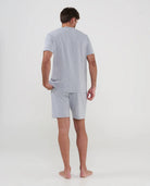 Hombre viste pijama azul veraniego con estampado de cochecitos, bolsillos y cintura ajustable