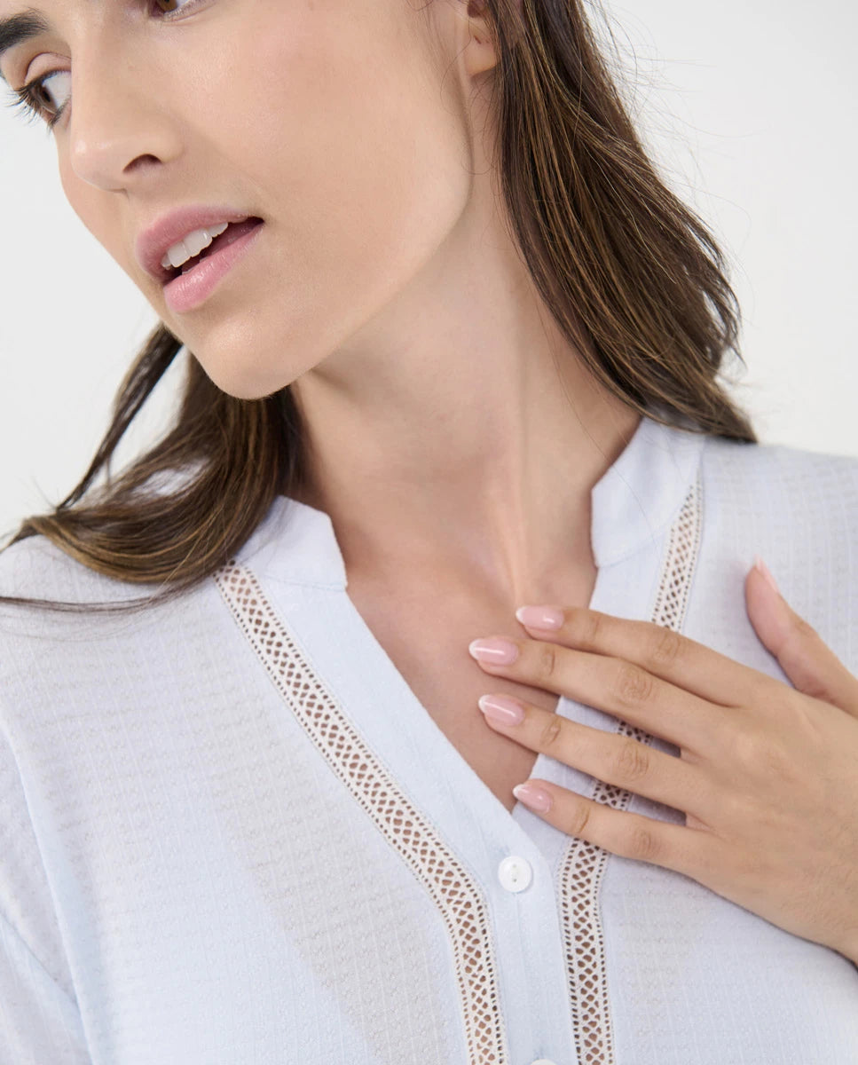 Detalle del escote en pico con entredós del pijama lencero de manga corta celeste para mujer