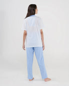 Vista trasera de conjunto de pijama largo de mujer para verano top blanco y pantalón cuadritos celeste