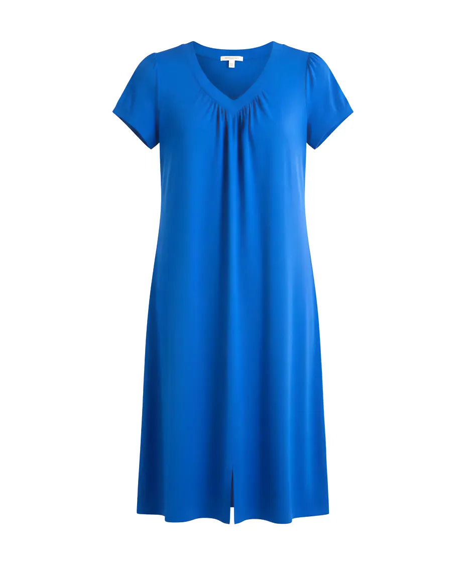 Mujer de espaldas con vestido corto de verano a topos multicolor manga corta
