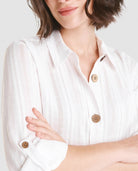 Mujer luce vestido largo abotonado color blanco con cuello camisero y sombrero de paja