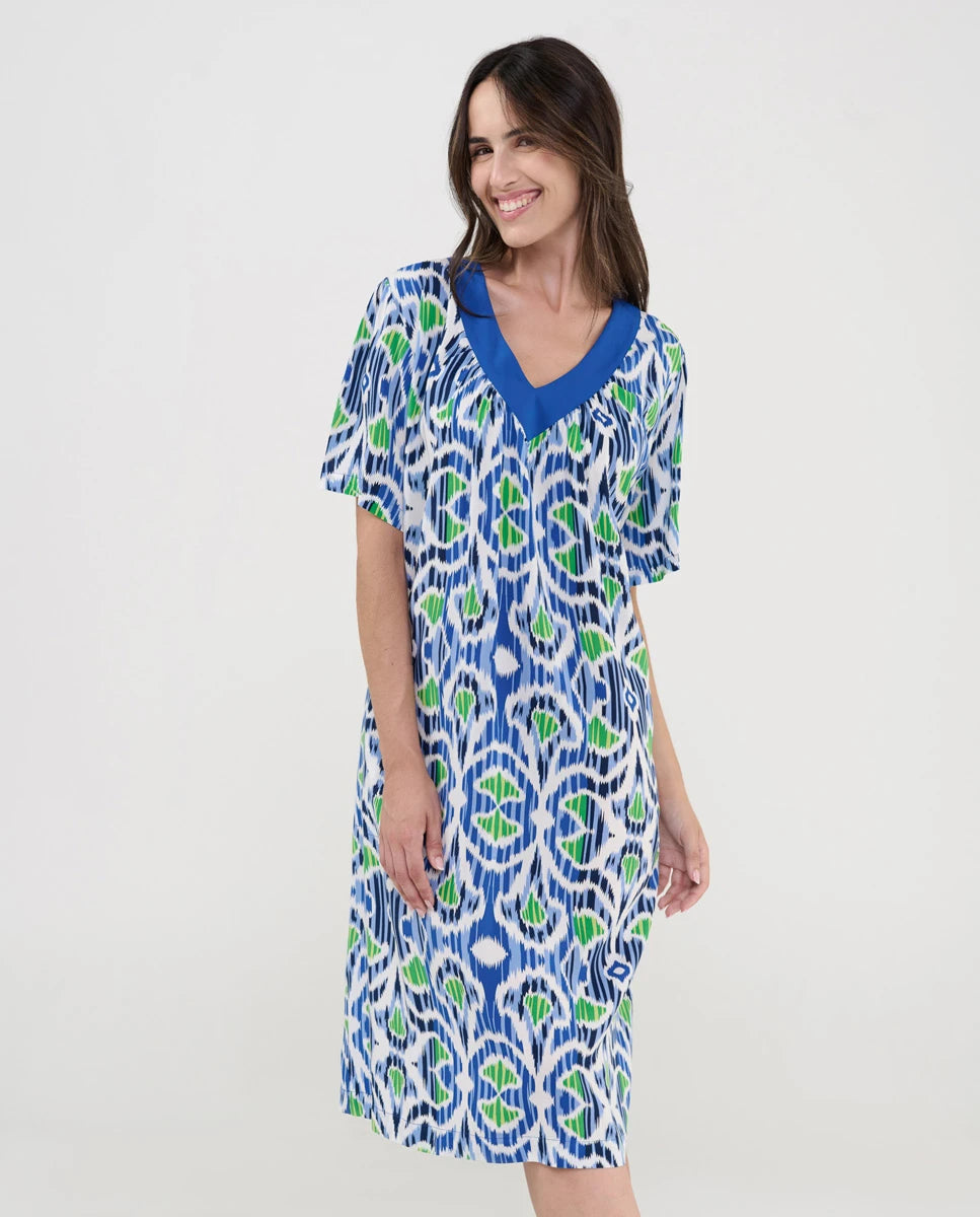 Mujer con vestido midi holgado con estampado étnico en azul, verde y blanco, cuello en V y manga corta